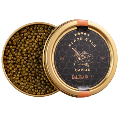 Open jar of Kaluga Gold caviar with golden pearls and lid nearby