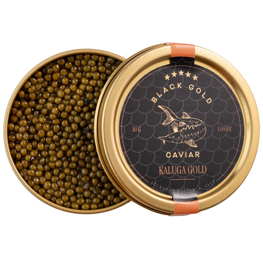 Open jar of Kaluga Gold caviar with golden pearls and lid nearby